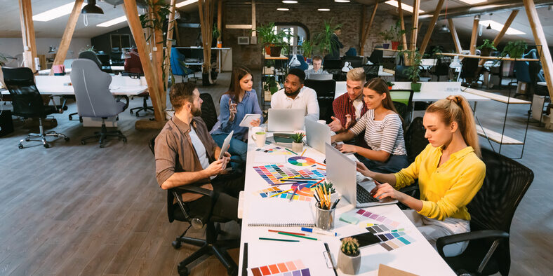 Coworking process. Designers working with project in modern office, panorama with free space