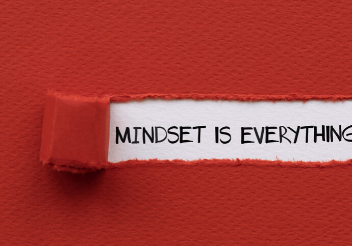 A torn red paper revealing the phrase "MINDSET IS EVERYTHING" written in black on a white background. This image emphasizes the critical role of one's attitude and perspective in achieving success and navigating challenges, ideal for themes of personal development, psychology, motivation, and resilience.